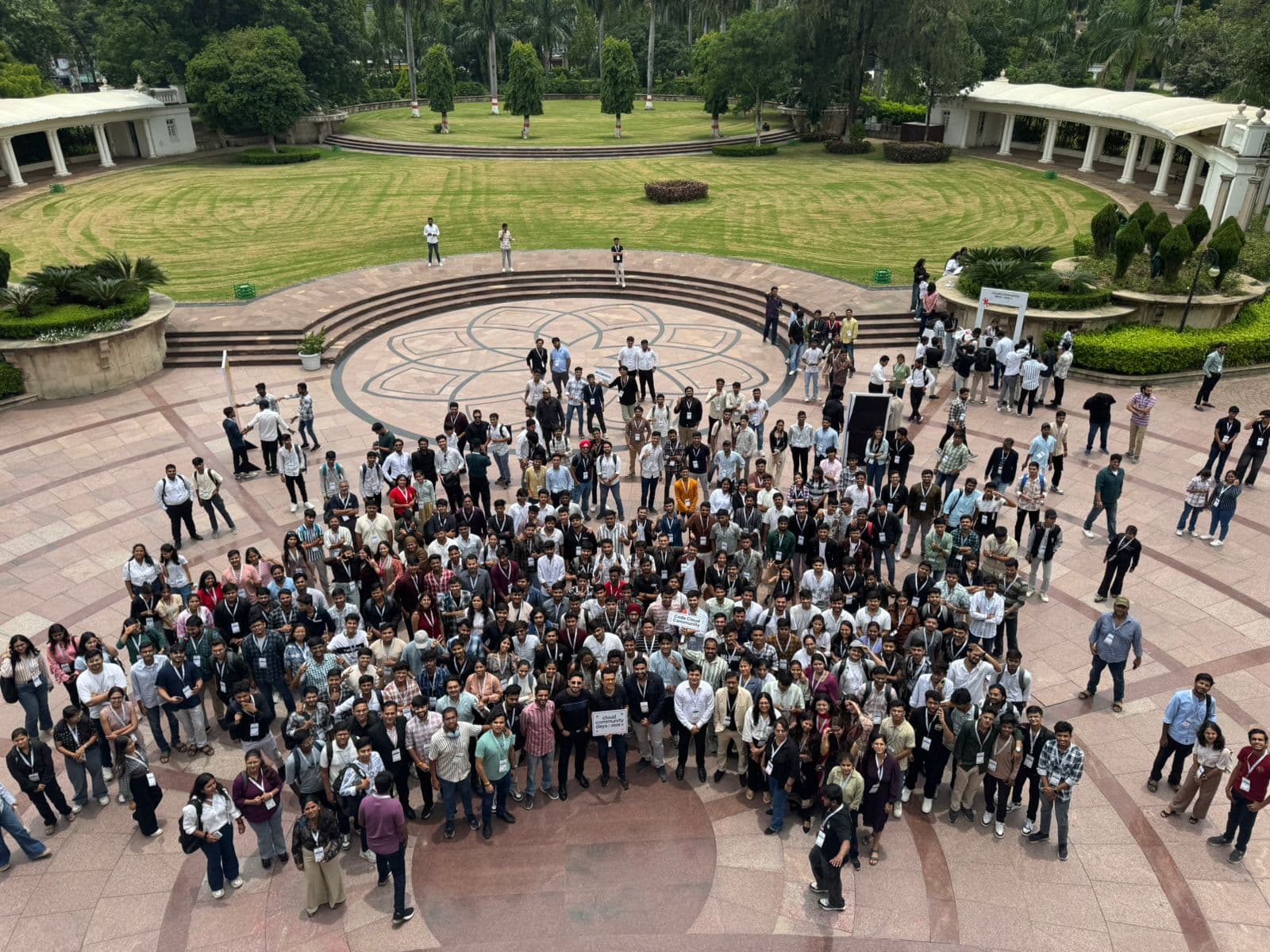 Open-air amphitheater full of developers and students holding the Cloud Community Days Bhopal banner